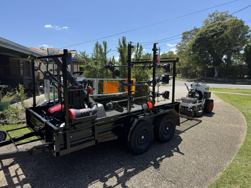 EcoMow professional equipment trailer with electric tools and Bobcat zero-turn mower for large suburban properties and overgrown restoration