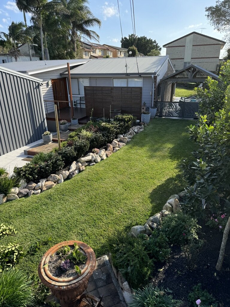 Beautiful sustainable garden transformation in Slacks Creek showing lush lawn, native plants, and eco-friendly landscaping